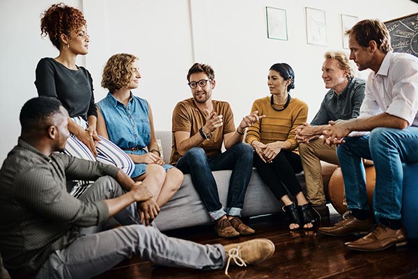 group of adults talking and listening to one another