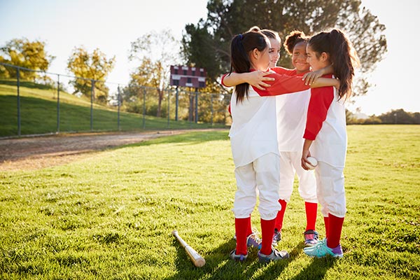 team of softball baseball players huddled up